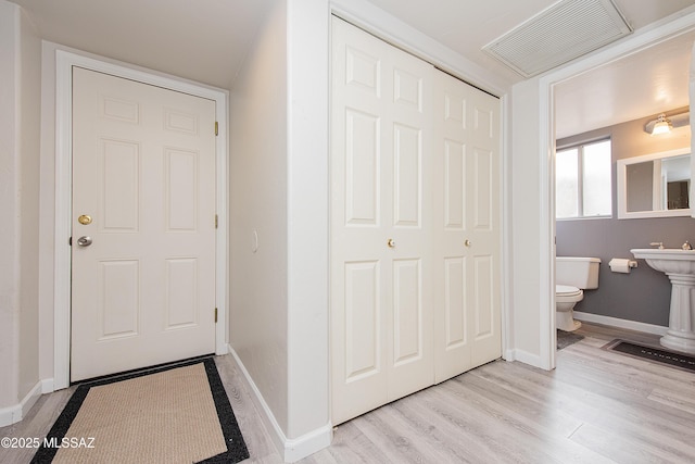 bathroom with toilet and hardwood / wood-style flooring