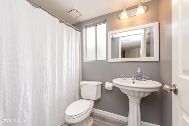 bathroom featuring toilet and hardwood / wood-style floors