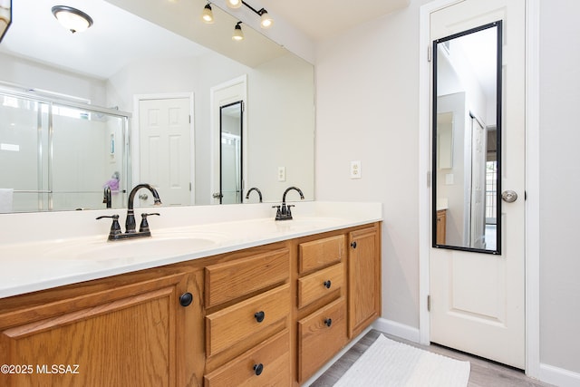 bathroom featuring an enclosed shower and vanity