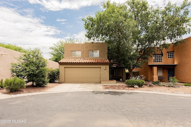 pueblo-style home with a garage