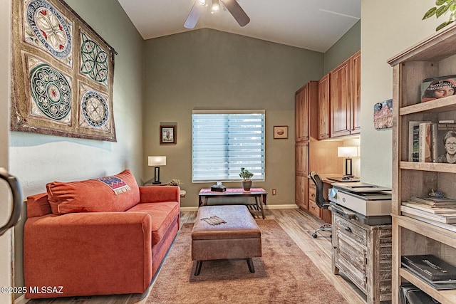 living room with ceiling fan, light wood-type flooring, and lofted ceiling