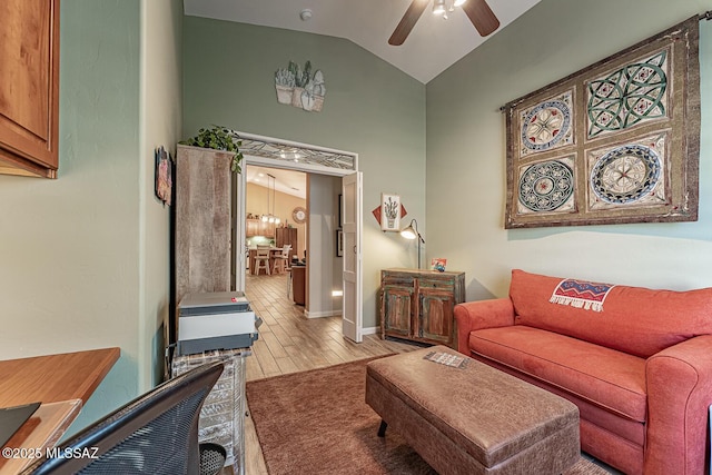 living room featuring ceiling fan, light hardwood / wood-style flooring, and lofted ceiling