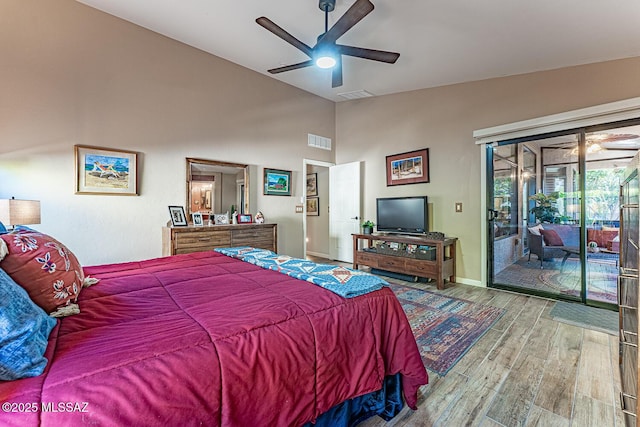 bedroom featuring lofted ceiling, hardwood / wood-style floors, ceiling fan, and access to outside