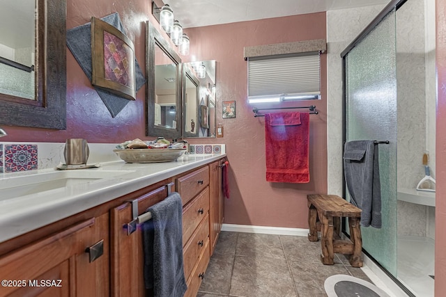 bathroom with a shower with door, tile patterned floors, and vanity