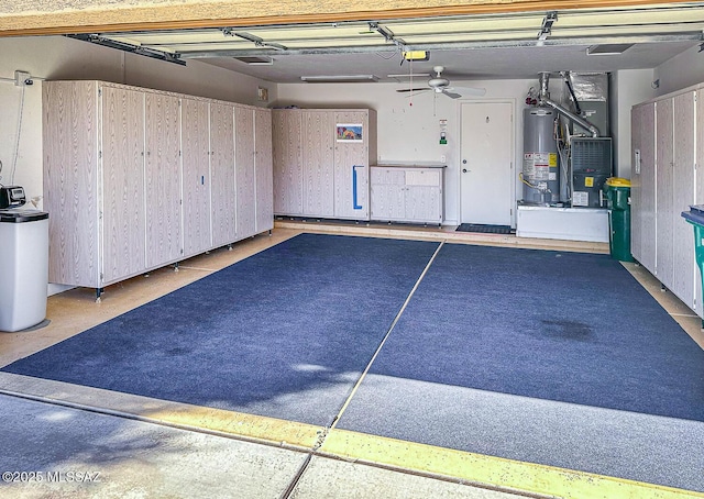 garage with a garage door opener, water heater, and ceiling fan