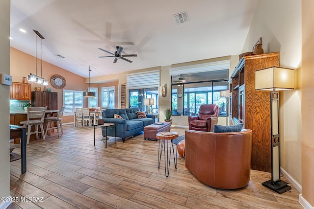 living room with ceiling fan and vaulted ceiling