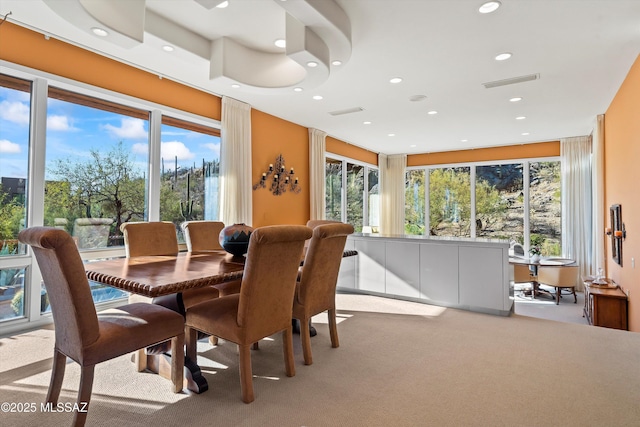 carpeted dining area featuring a wealth of natural light