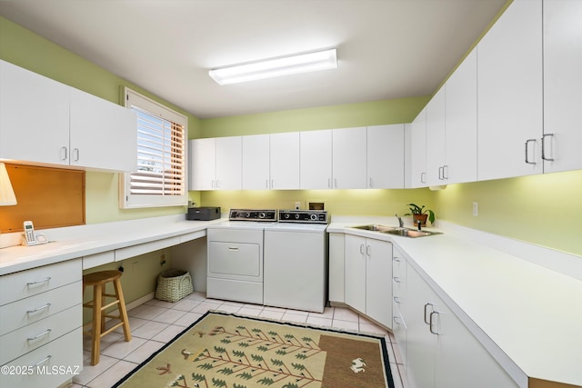 clothes washing area featuring cabinets, light tile patterned floors, sink, and washing machine and clothes dryer