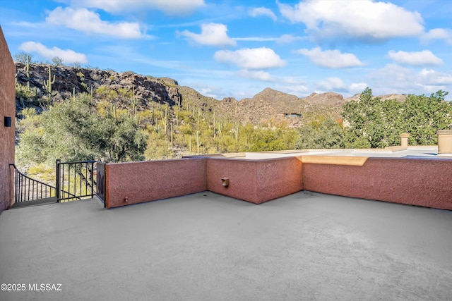 balcony featuring a mountain view and a patio