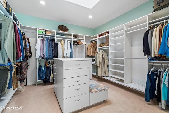 walk in closet featuring light carpet