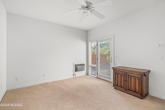 carpeted empty room with heating unit and ceiling fan