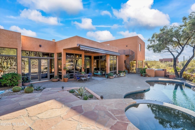 view of pool featuring a patio area and an in ground hot tub