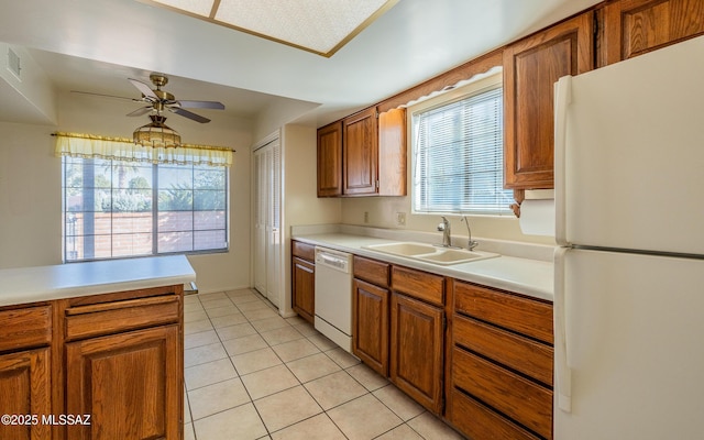 kitchen featuring light tile patterned floors, white appliances, ceiling fan, and sink