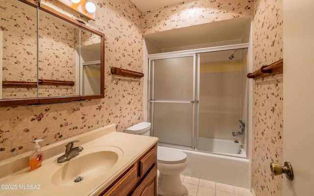 full bathroom with tile patterned flooring, toilet, combined bath / shower with glass door, and vanity