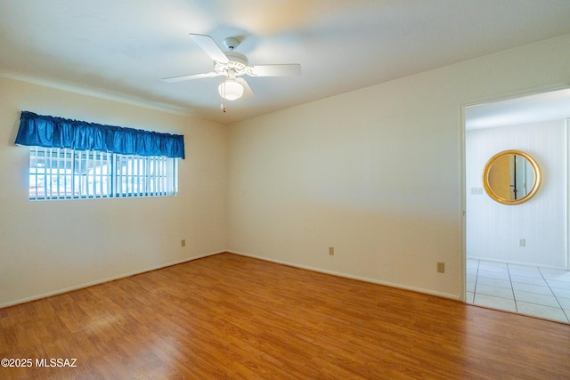 unfurnished room featuring hardwood / wood-style floors and ceiling fan