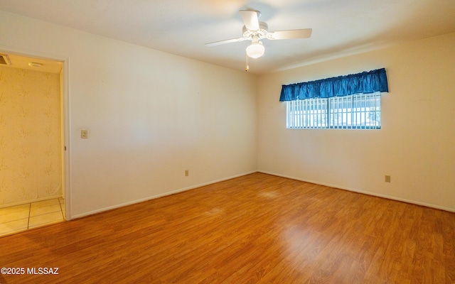 empty room with hardwood / wood-style flooring and ceiling fan