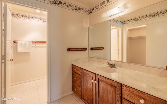 bathroom with tile patterned floors and vanity