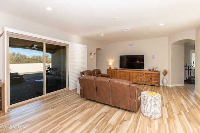 living room featuring ceiling fan and light hardwood / wood-style flooring