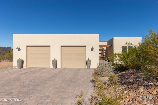 pueblo revival-style home with a garage