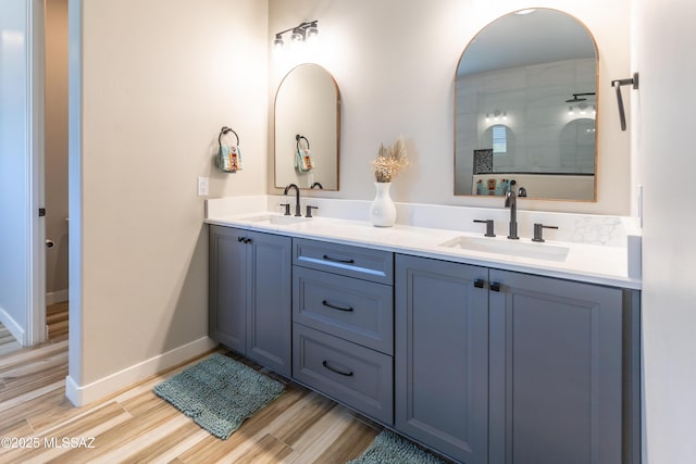 bathroom with a shower, wood-type flooring, and vanity