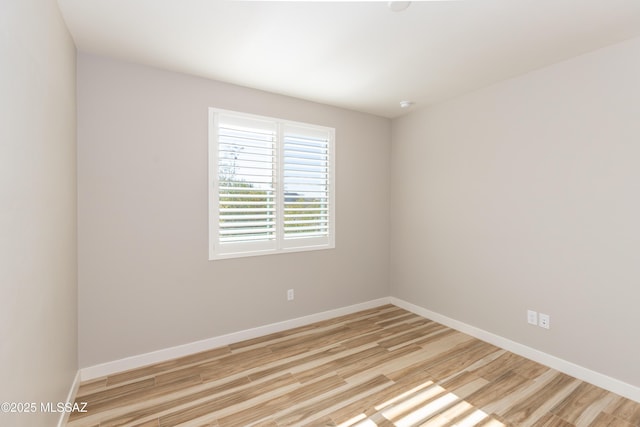 spare room featuring light wood-type flooring