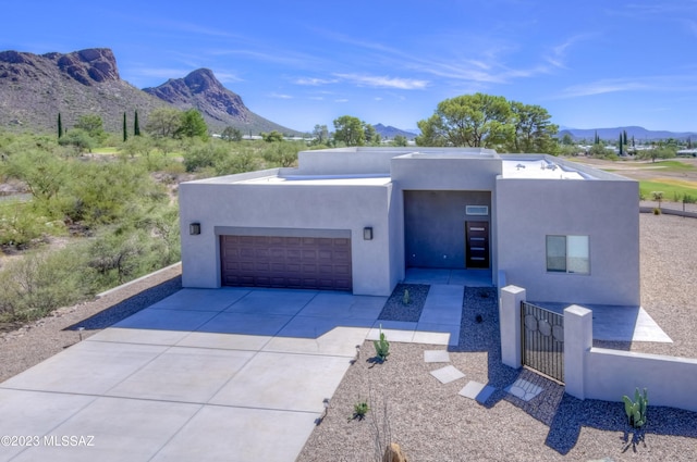 view of front facade featuring a mountain view and a garage