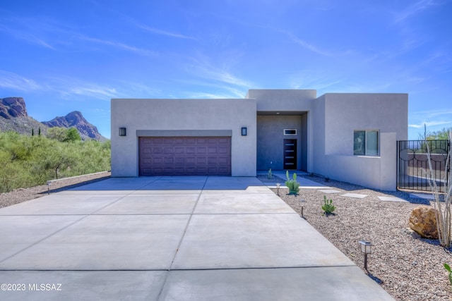 view of front of property with a mountain view and a garage