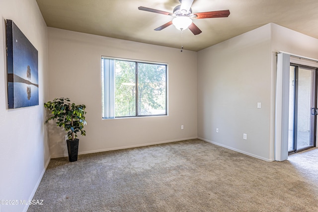 empty room with ceiling fan and light colored carpet