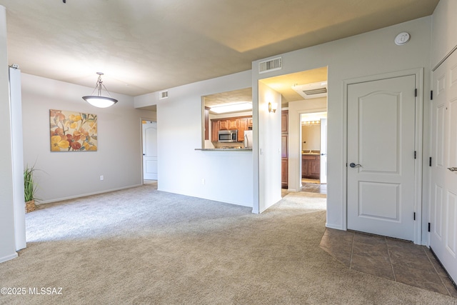 unfurnished living room featuring dark carpet