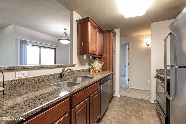 kitchen featuring pendant lighting, sink, and appliances with stainless steel finishes