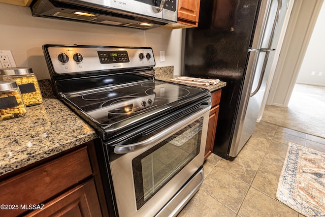 kitchen featuring light carpet, stainless steel appliances, and light stone counters