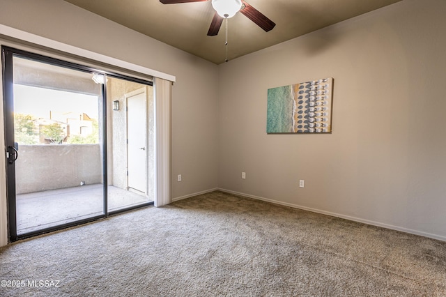 carpeted spare room featuring ceiling fan