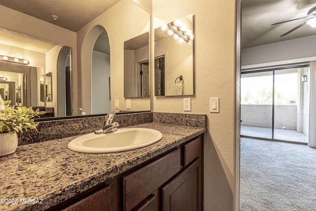 bathroom with ceiling fan and vanity