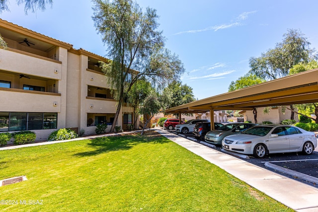 view of vehicle parking with a lawn