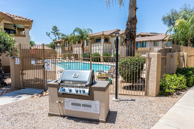 exterior space featuring grilling area and a community pool