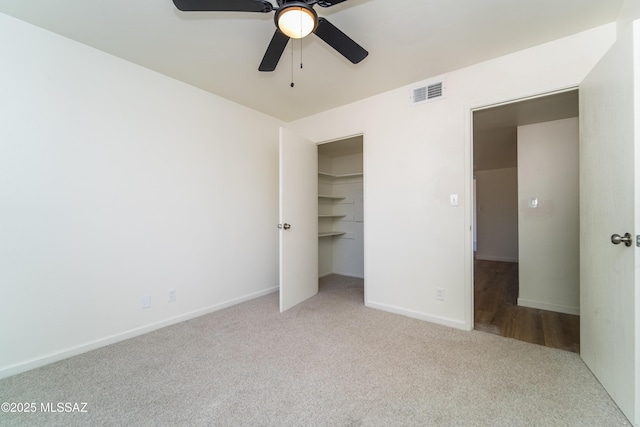 unfurnished bedroom featuring light colored carpet and ceiling fan