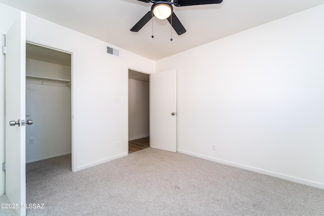 unfurnished bedroom with light carpet, a closet, and ceiling fan