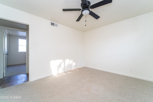 carpeted spare room featuring ceiling fan