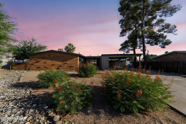 back house at dusk with a carport