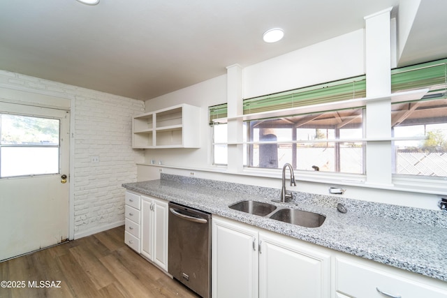 kitchen featuring sink, light stone counters, light hardwood / wood-style flooring, stainless steel dishwasher, and white cabinets