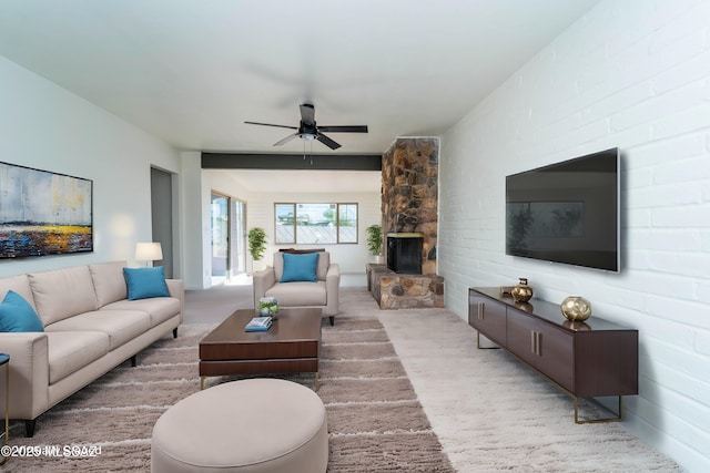 living room with ceiling fan, carpet floors, and a fireplace