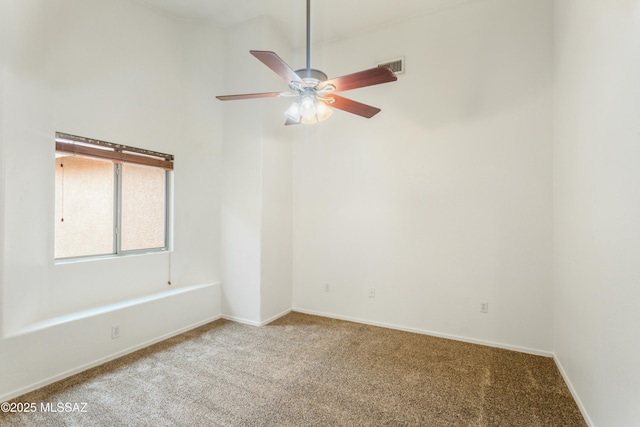 empty room featuring carpet flooring and ceiling fan