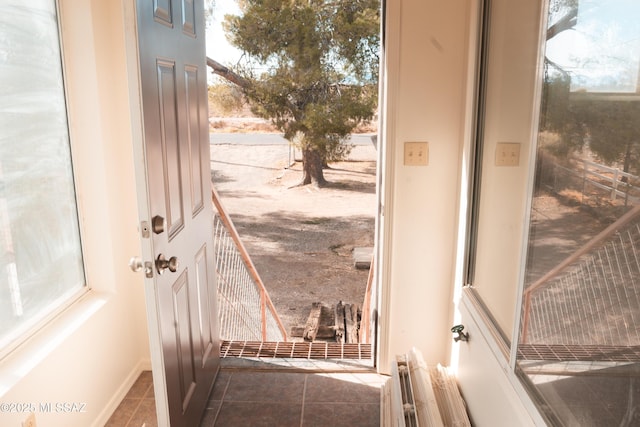 doorway featuring tile patterned flooring and radiator