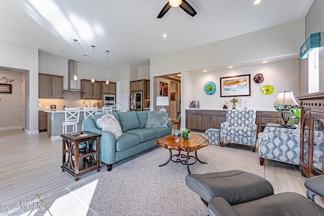 living room with ceiling fan and sink