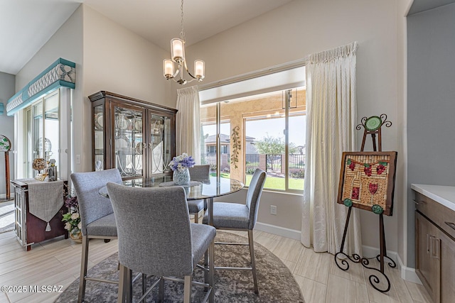 dining area with a healthy amount of sunlight, vaulted ceiling, and a chandelier