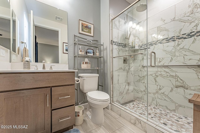 bathroom with vanity, toilet, and walk in shower