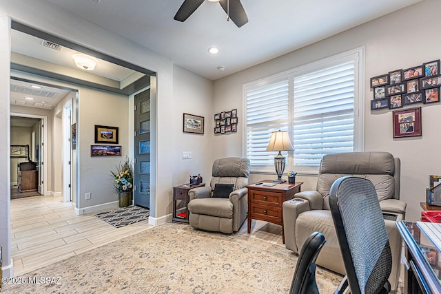 sitting room featuring ceiling fan