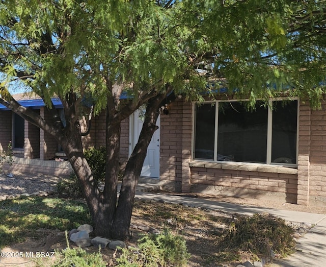 view of front of house featuring brick siding