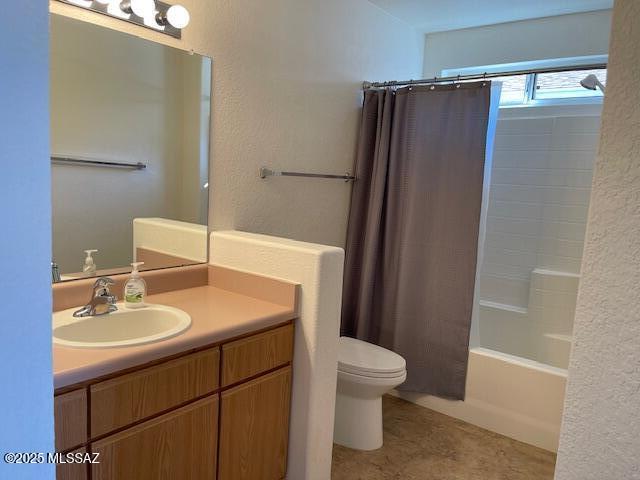 full bathroom featuring vanity, shower / bath combination with curtain, and toilet