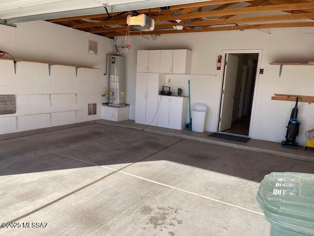 garage with a garage door opener and gas water heater